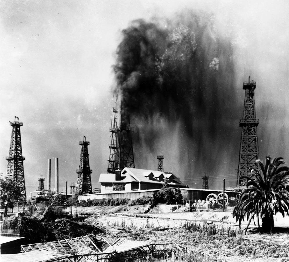 Black Gold - Oil gushing out of oil tower.